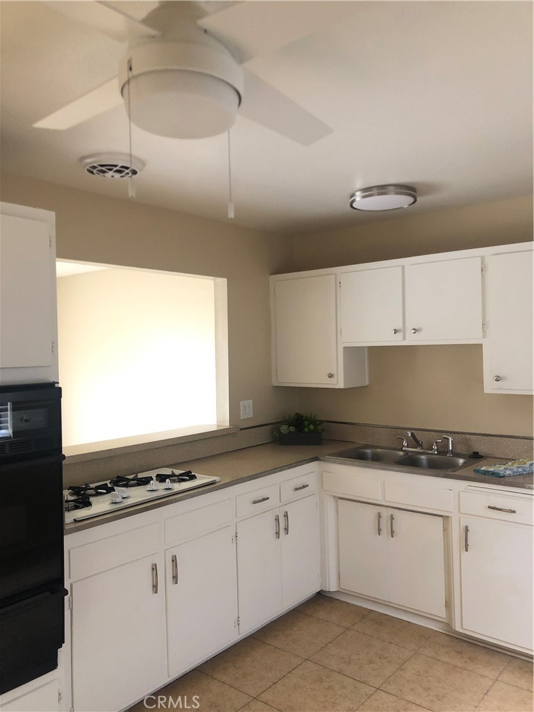264 Cabrillo Street Costa Mesa, CA 92627 - Photo 5 of 17 a kitchen with granite countertop a sink and cabinets