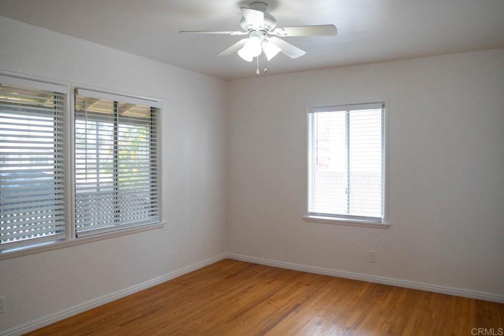 15523 Studebaker Road Norwalk, CA 90650 - Photo 17 of 59 a view of an empty room with wooden floor and a window
