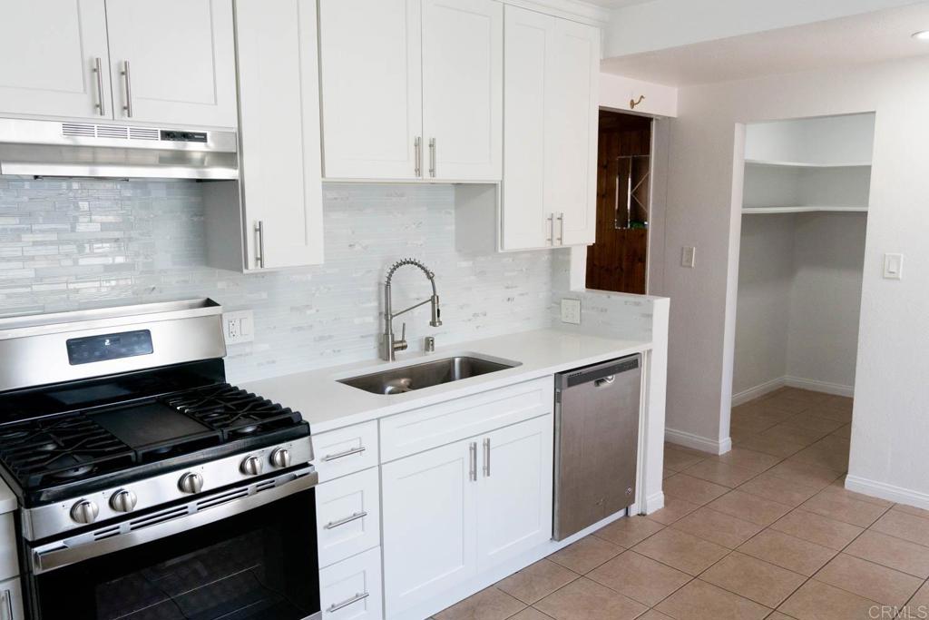15523 Studebaker Road Norwalk, CA 90650 - Photo 23 of 59 a kitchen with appliances a sink and cabinets