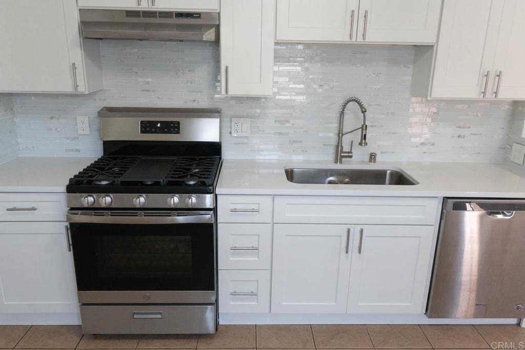 15523 Studebaker Road Norwalk, CA 90650 - Photo 24 of 59 a kitchen with stainless steel appliances granite countertop a stove and a sink