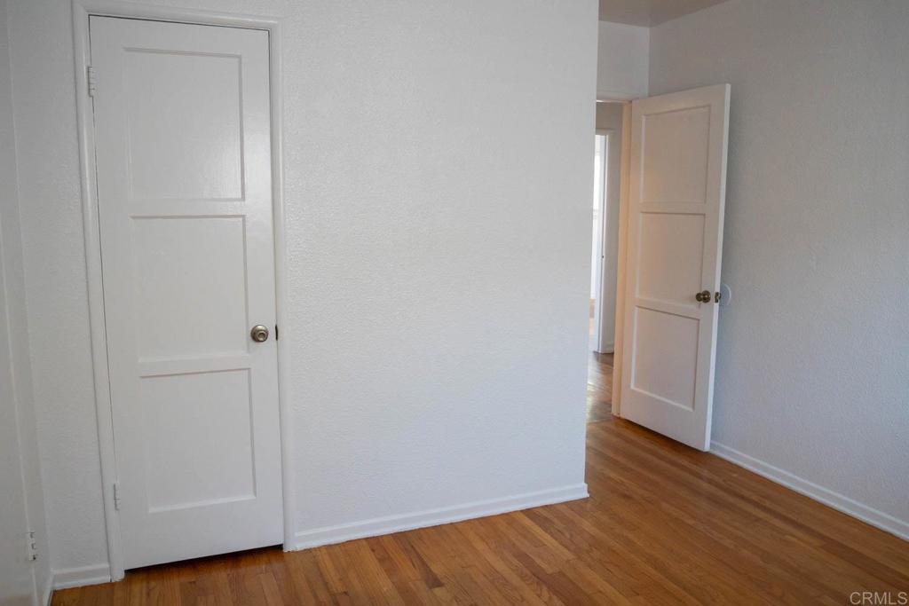 15523 Studebaker Road Norwalk, CA 90650 - Photo 27 of 59 an empty room with wooden floor and closet
