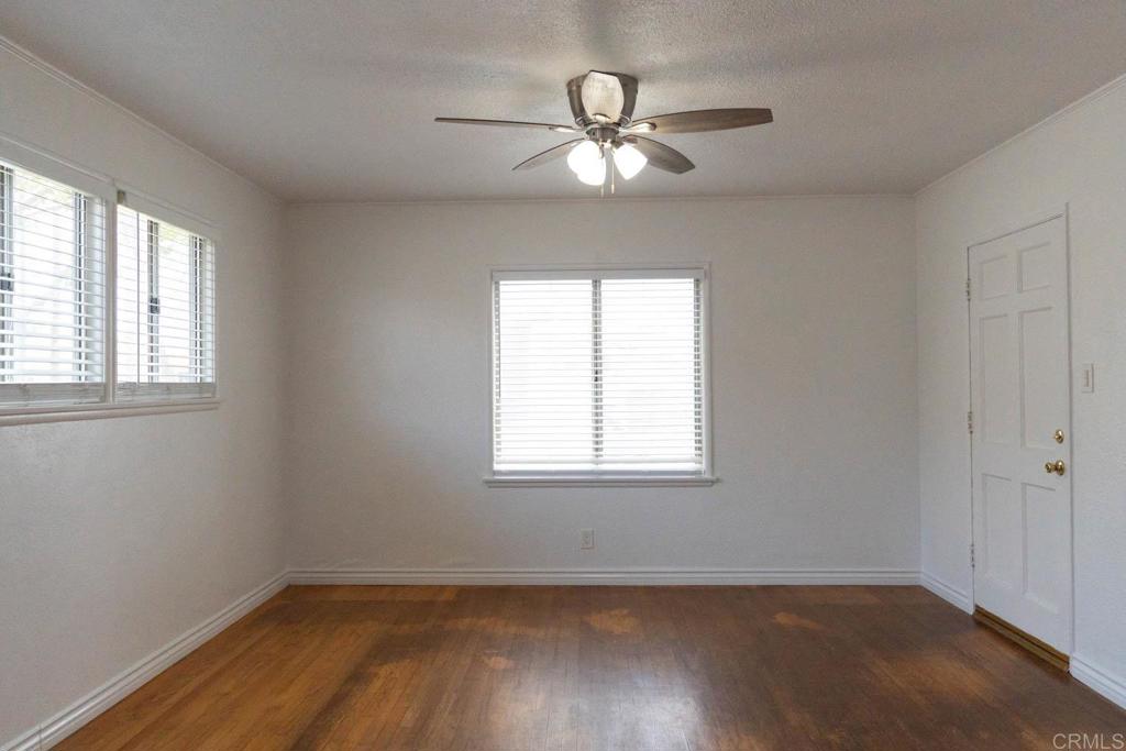 15523 Studebaker Road Norwalk, CA 90650 - Photo 28 of 59 an empty room with wooden floor and windows