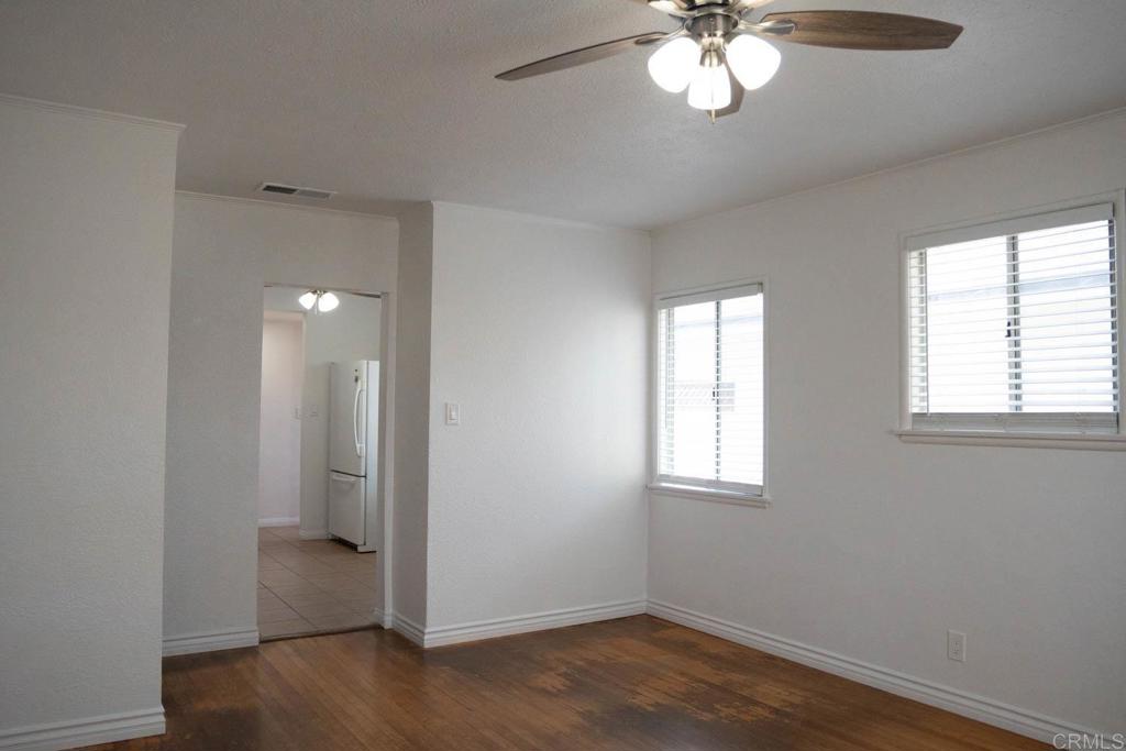15523 Studebaker Road Norwalk, CA 90650 - Photo 30 of 59 a view of an empty room with a window and wooden floor