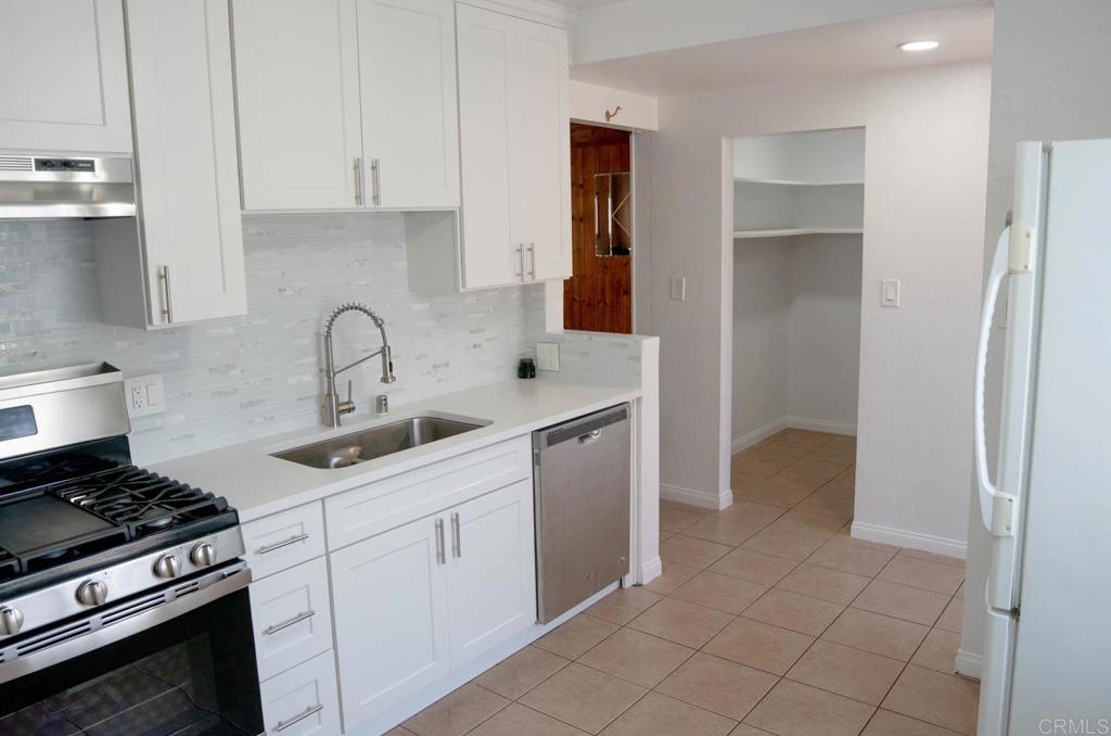 15523 Studebaker Road Norwalk, CA 90650 - Photo 34 of 59 a kitchen with a sink and a stove top oven