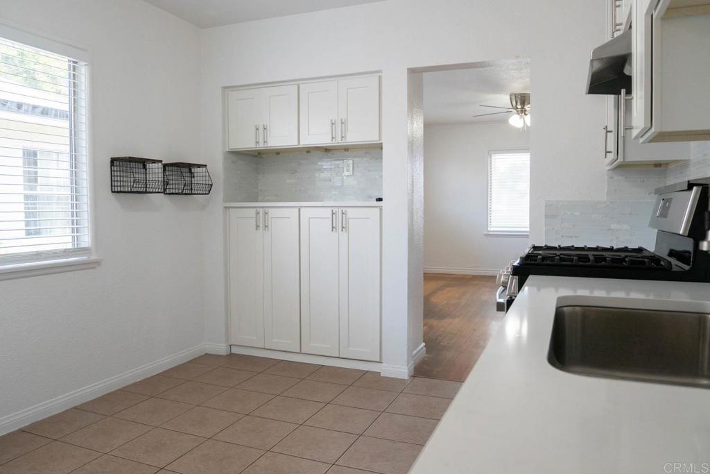 15523 Studebaker Road Norwalk, CA 90650 - Photo 35 of 59 a kitchen with granite countertop white cabinets and stainless steel appliances