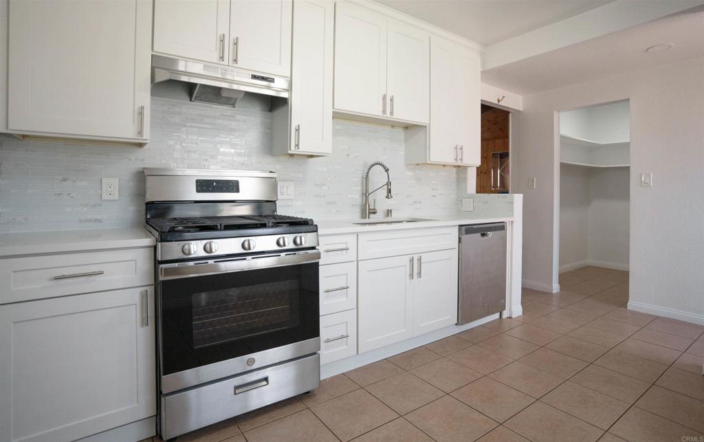 15523 Studebaker Road Norwalk, CA 90650 - Photo 38 of 59 a kitchen with cabinets stainless steel appliances and a sink