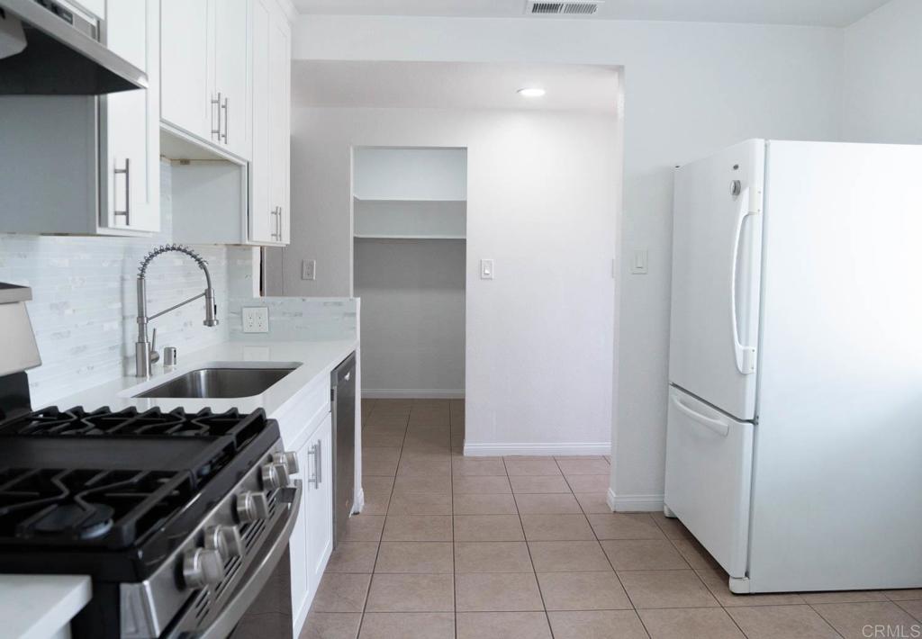 15523 Studebaker Road Norwalk, CA 90650 - Photo 4 of 59 a kitchen with stainless steel appliances granite countertop a refrigerator and a stove
