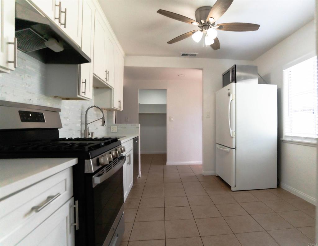 15523 Studebaker Road Norwalk, CA 90650 - Photo 43 of 59 a kitchen with stainless steel appliances granite countertop a stove a refrigerator and a sink