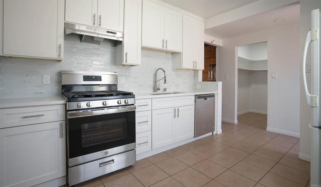 15523 Studebaker Road Norwalk, CA 90650 - Photo 44 of 59 a kitchen with cabinets stainless steel appliances and a sink