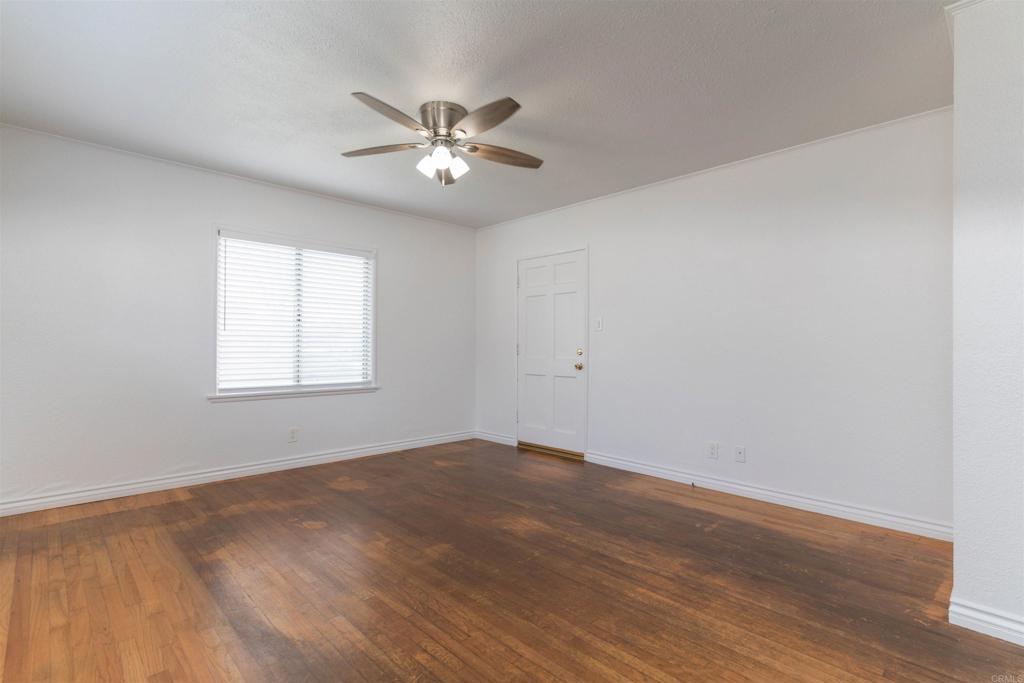 15523 Studebaker Road Norwalk, CA 90650 - Photo 53 of 59 a view of empty room with wooden floor and fan