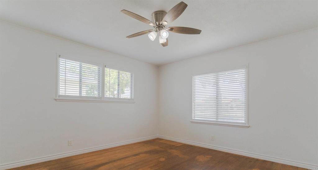15523 Studebaker Road Norwalk, CA 90650 - Photo 54 of 59 a view of an empty room with wooden floor and a ceiling fan