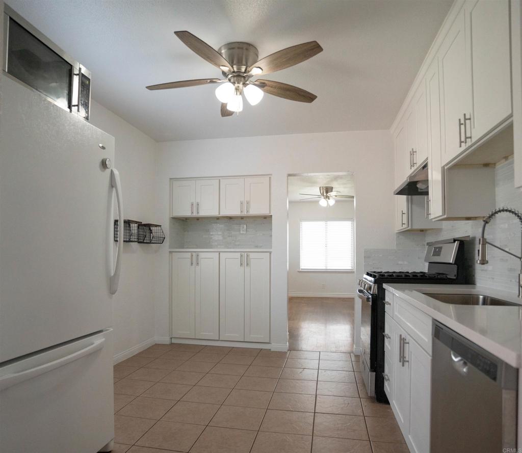 15523 Studebaker Road Norwalk, CA 90650 - Photo 57 of 59 a kitchen with stainless steel appliances a sink a stove a refrigerator cabinets and a window