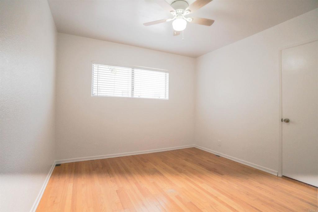 15523 Studebaker Road Norwalk, CA 90650 - Photo 6 of 59 an empty room with a window and wooden floor
