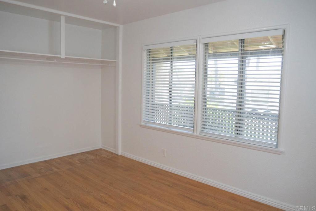 15523 Studebaker Road Norwalk, CA 90650 - Photo 7 of 59 a view of an empty room with wooden floor and a window