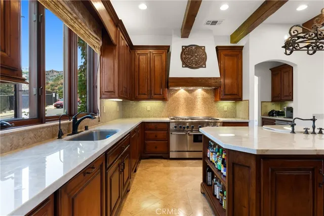 a kitchen with granite countertop a sink stove and cabinets