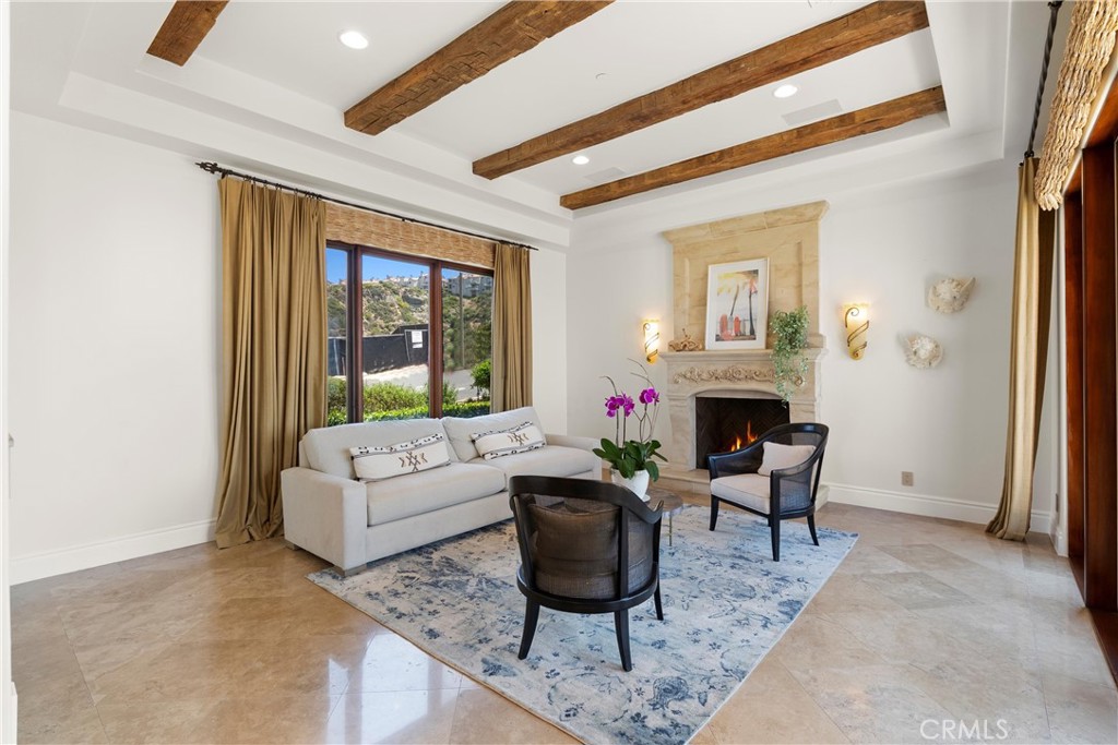 4 Le Conte Laguna Niguel, CA 92677 - Photo 17 of 65 a living room with furniture a fireplace and a table