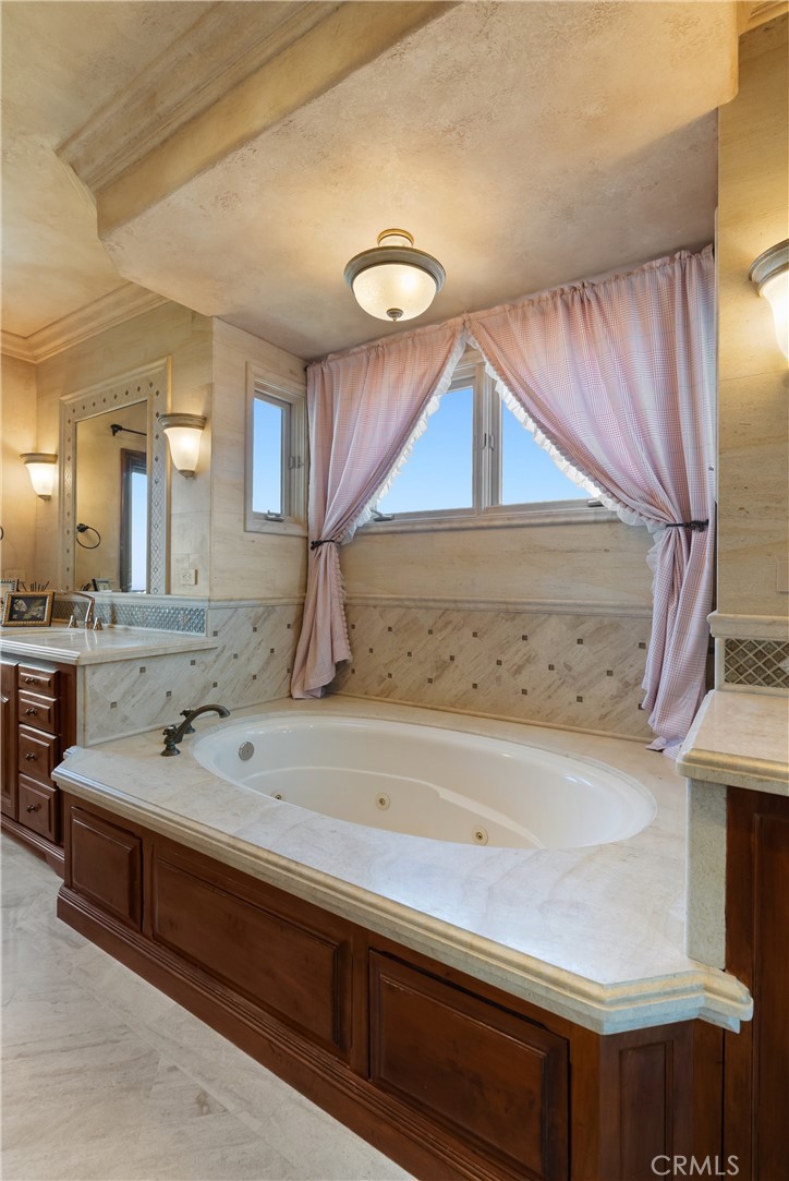 4 Le Conte Laguna Niguel, CA 92677 - Photo 27 of 65 a bathroom with a sink a mirror and a bathtub