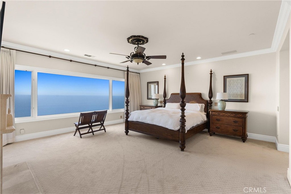 4 Le Conte Laguna Niguel, CA 92677 - Photo 29 of 65 a spacious bedroom with a bed and a chandelier