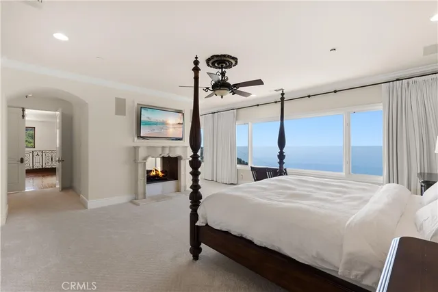 a bedroom with a large bed and a chandelier