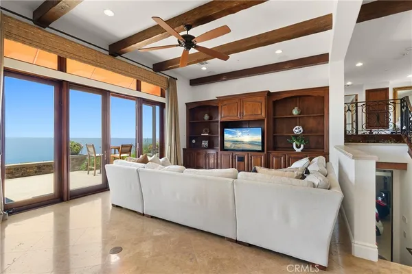 a living room with furniture a large window and flat screen tv