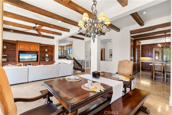 a view of a dining room with furniture a chandelier and wooden floor