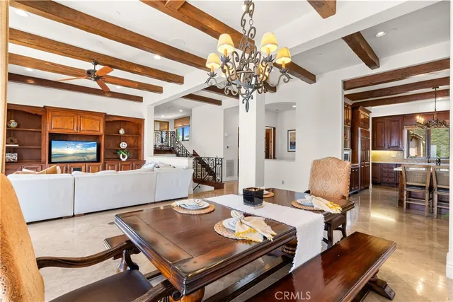 a view of a dining room with furniture a chandelier and wooden floor