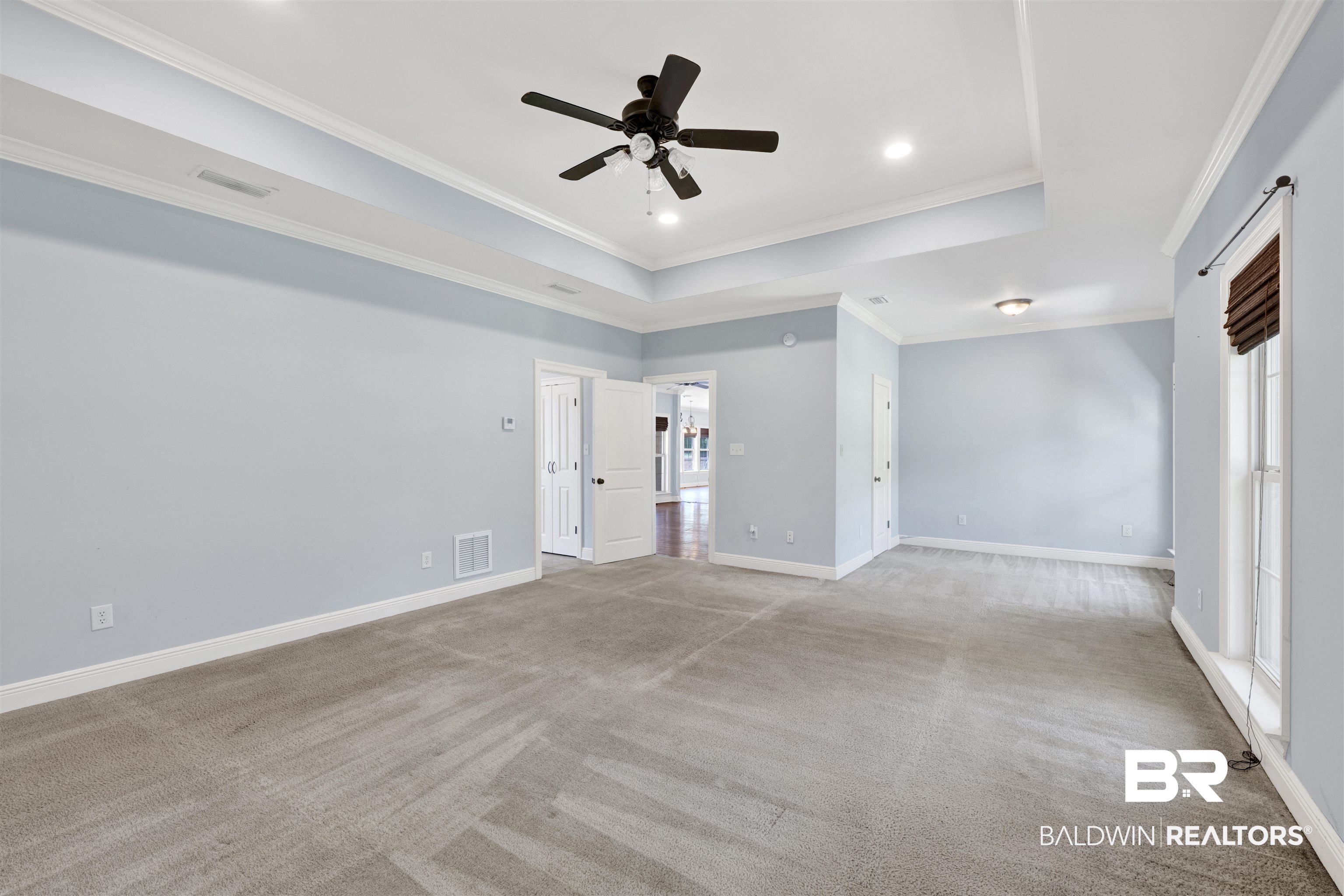 12944 Anna's Way Stapleton, AL 36578 - Photo 48 of 64 Spacious carpeted room featuring a tray ceiling with recessed lighting and a ceiling fan