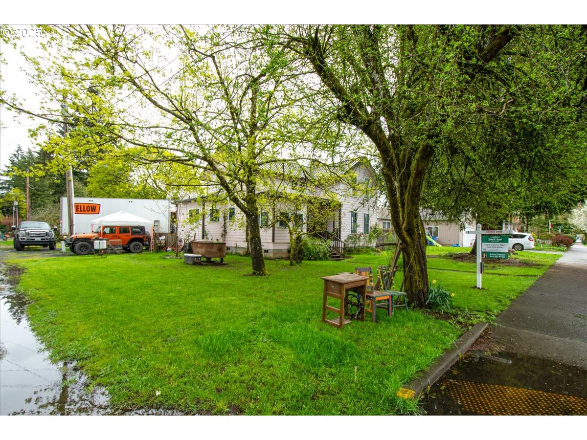 514 North Main Avenue Ridgefield, WA 98642 - Photo 14 of 16 a garden with trees in front of it