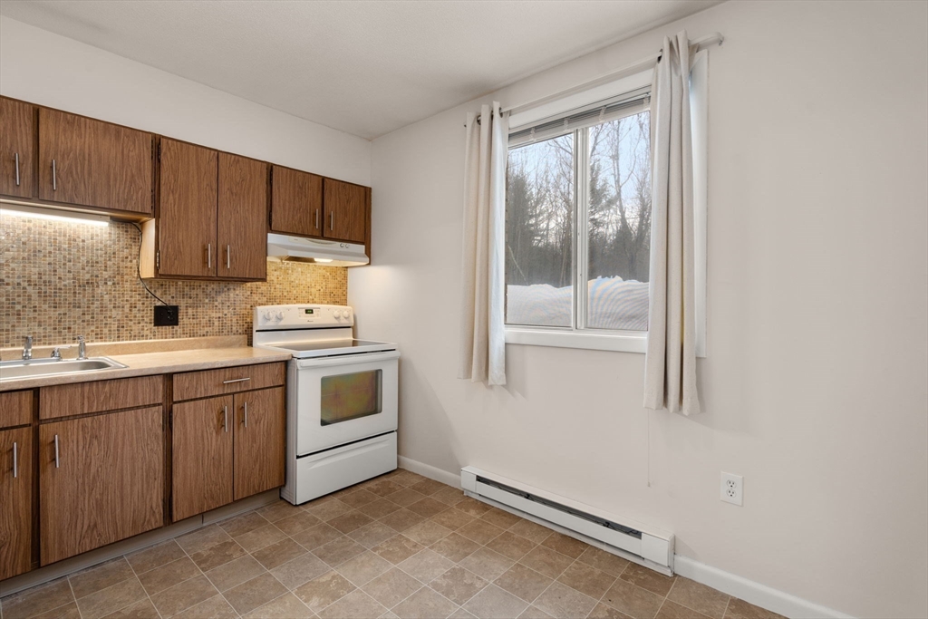 121 Bailey Street, Unit D31 Worcester, MA 01602 - Photo 11 of 25 a kitchen with a stove sink and cabinets