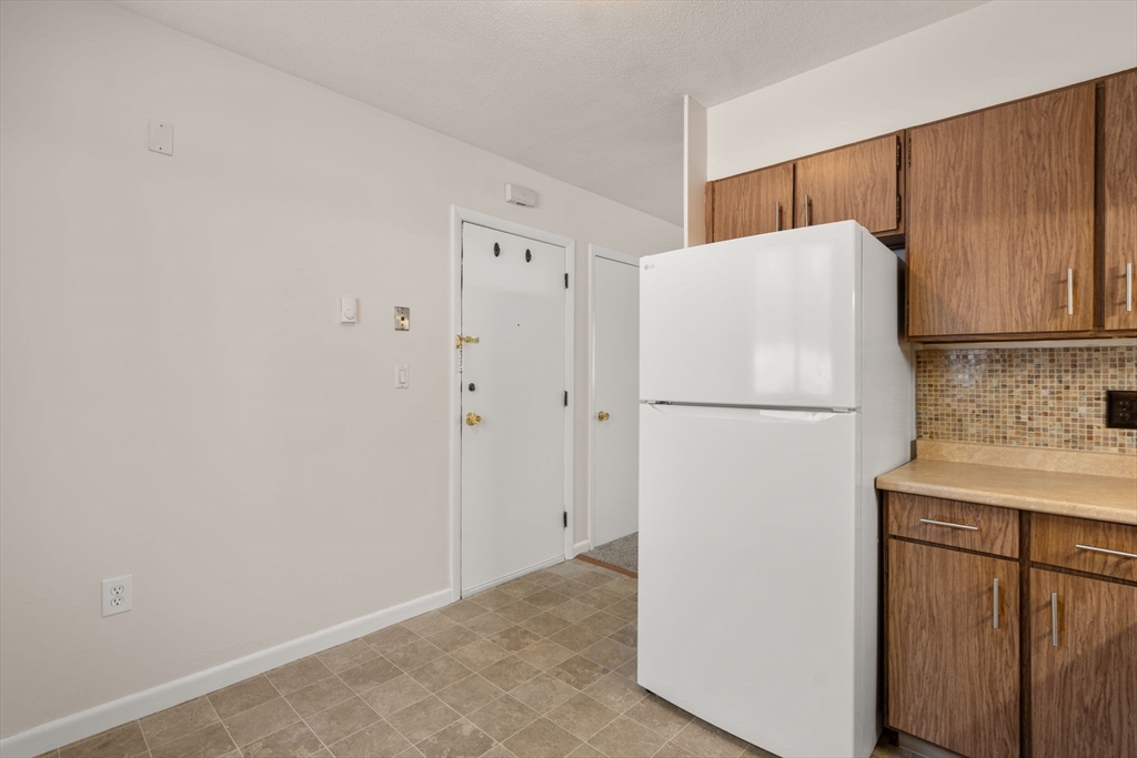 121 Bailey Street, Unit D31 Worcester, MA 01602 - Photo 12 of 25 a white refrigerator freezer sitting in a kitchen