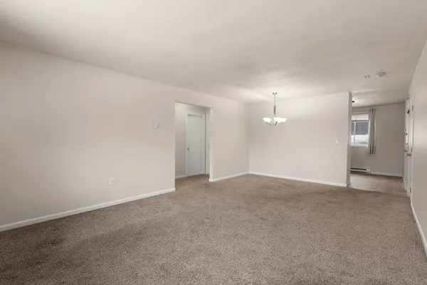 a view of an empty room with a bathroom