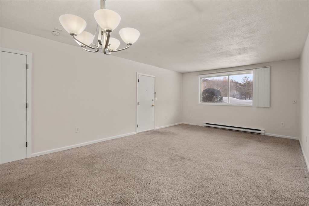 121 Bailey Street, Unit D31 Worcester, MA 01602 - Photo 4 of 25 a view of an empty room with a chandelier fan