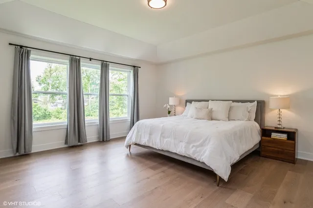 a bedroom with a large bed and a large window