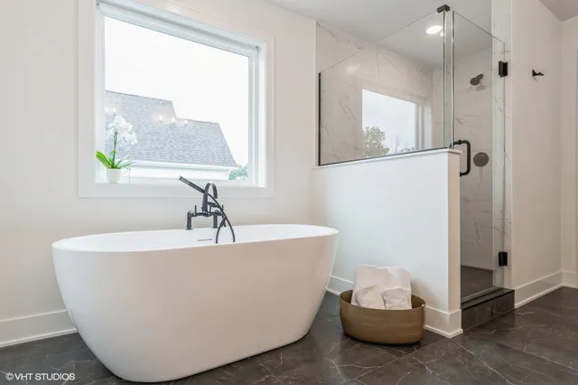 a white bath tub sitting next to a window