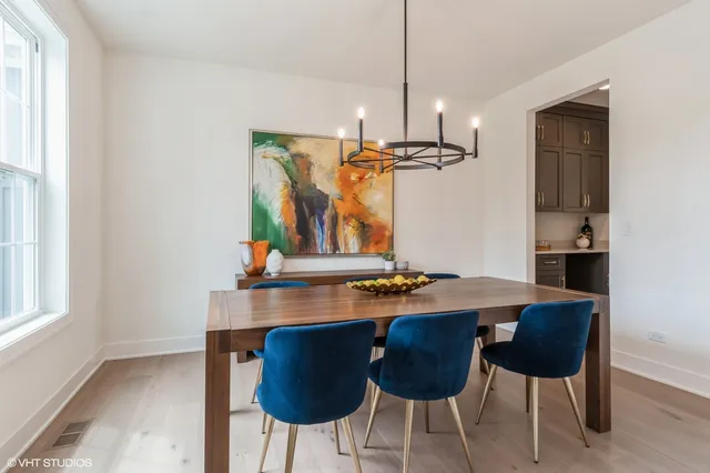 a view of a dining room with furniture and chandelier