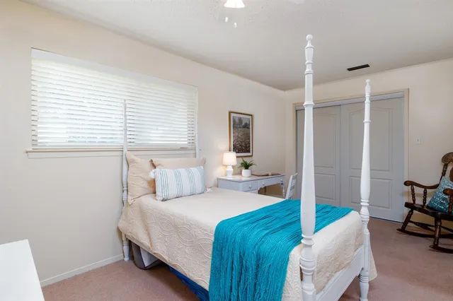 a bedroom with a large bed and a large window