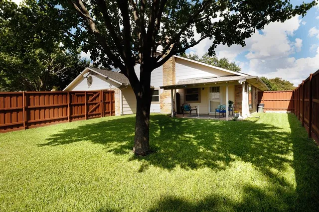 a view of chairs and table in backyard