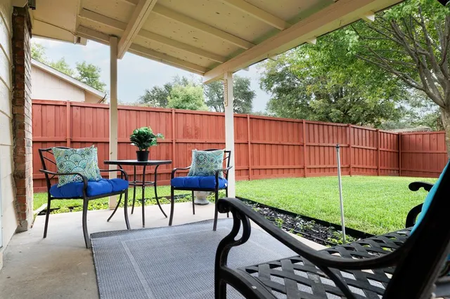 a view of backyard with seating area and green space
