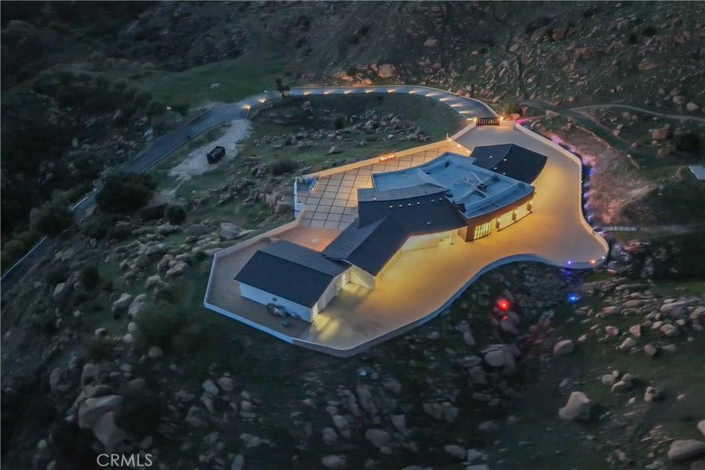 an aerial view of a house with a yard