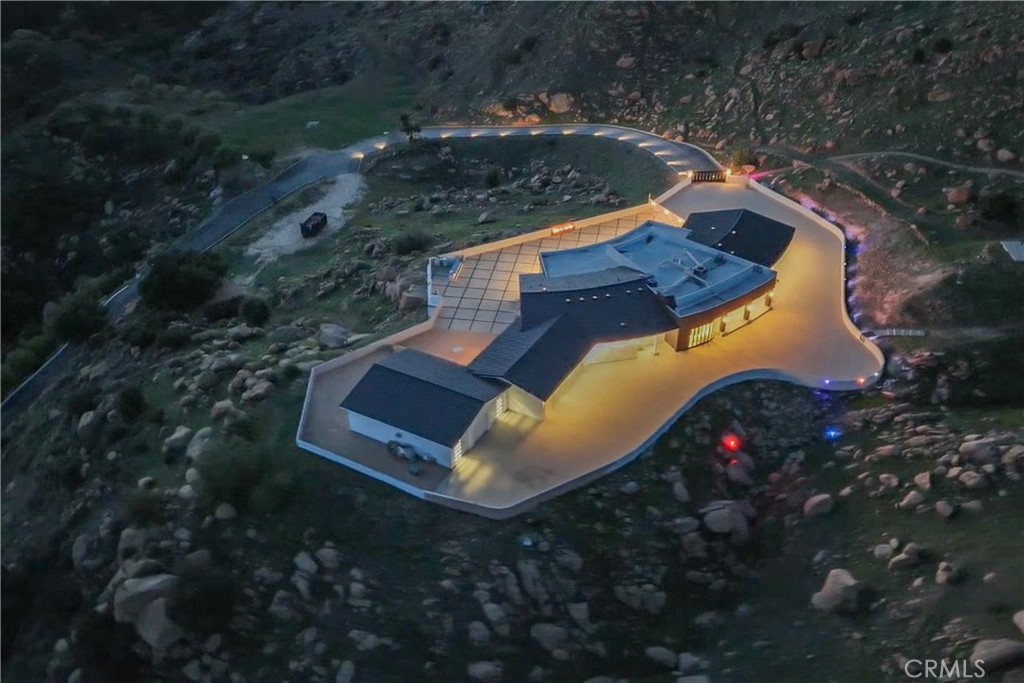 an aerial view of a house with a yard