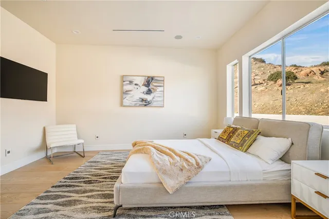 a living room with furniture a flat screen tv and a painting on the wall