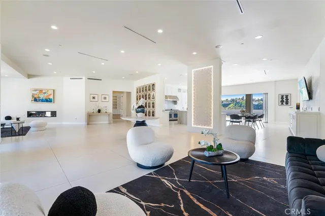 a dining room with furniture a view of living room and windows