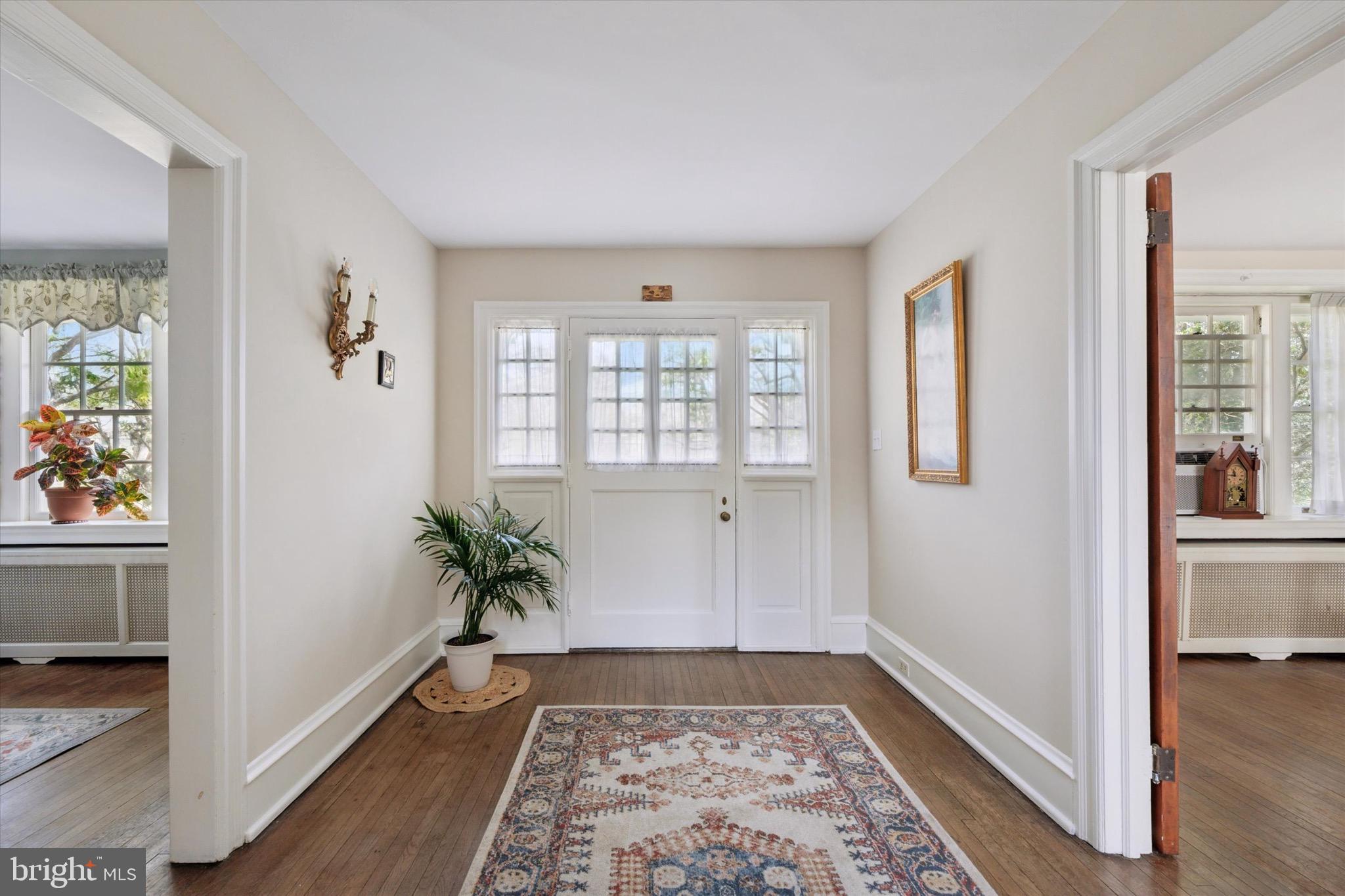 402 Penn Road Wynnewood, PA 19096 - Photo 22 of 75 a view of hallway with wooden floor and a livingroom