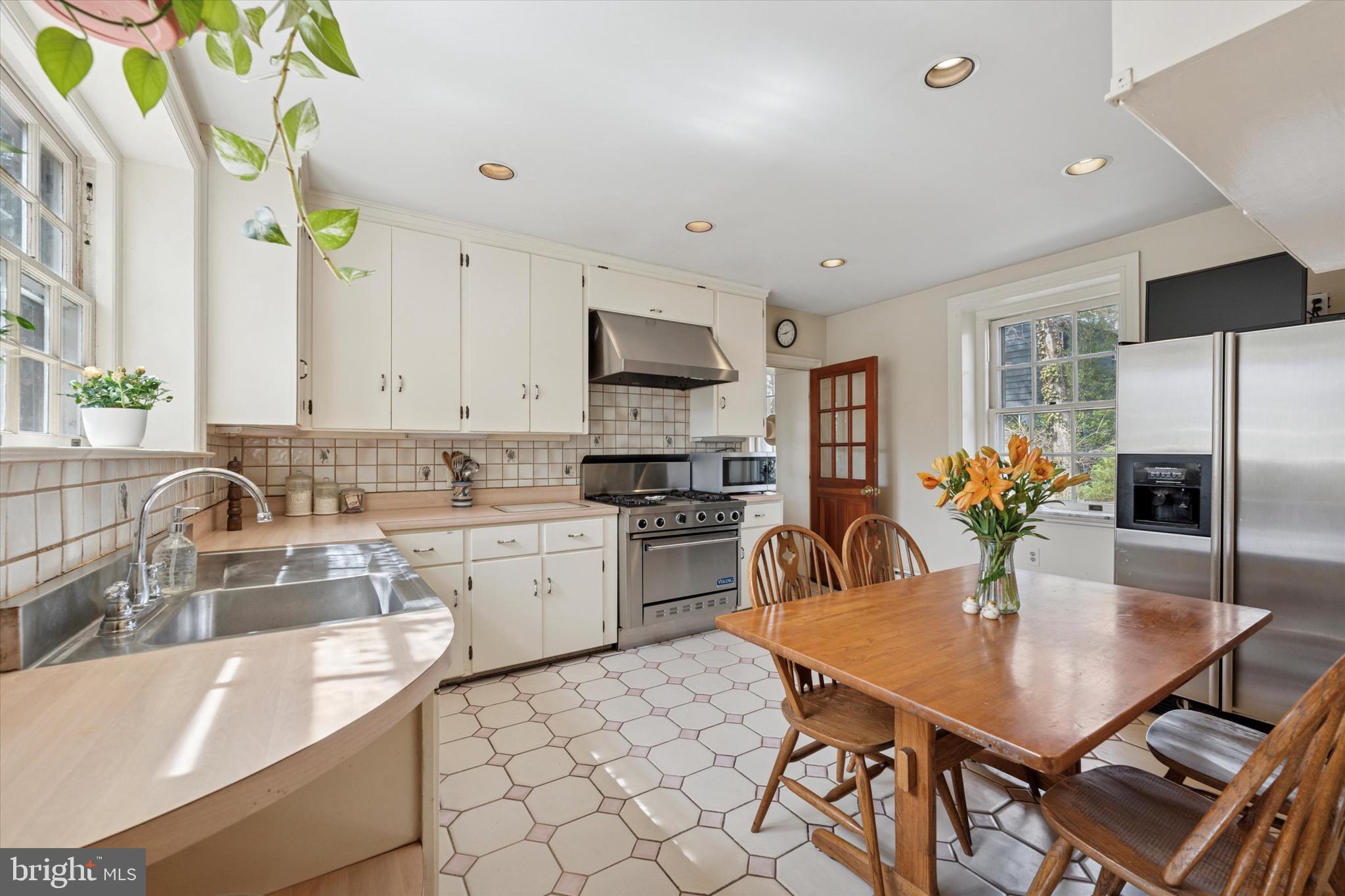 402 Penn Road Wynnewood, PA 19096 - Photo 38 of 75 a kitchen with a dining table chairs stainless steel appliances and cabinets