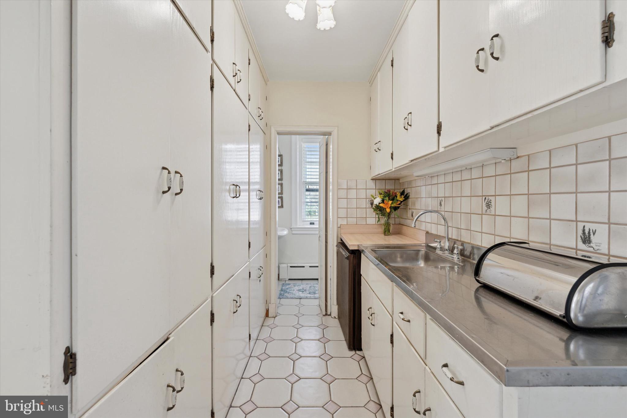 402 Penn Road Wynnewood, PA 19096 - Photo 42 of 75 a kitchen with a sink and cabinets