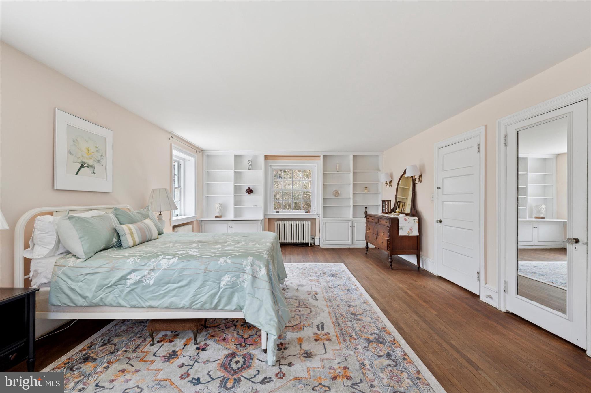 402 Penn Road Wynnewood, PA 19096 - Photo 46 of 75 a spacious bedroom with a bed a couch and large window