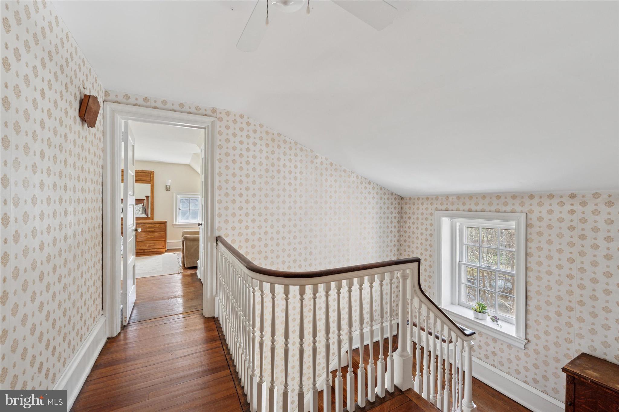 402 Penn Road Wynnewood, PA 19096 - Photo 61 of 75 a view of a hallway with wooden floor and stairs