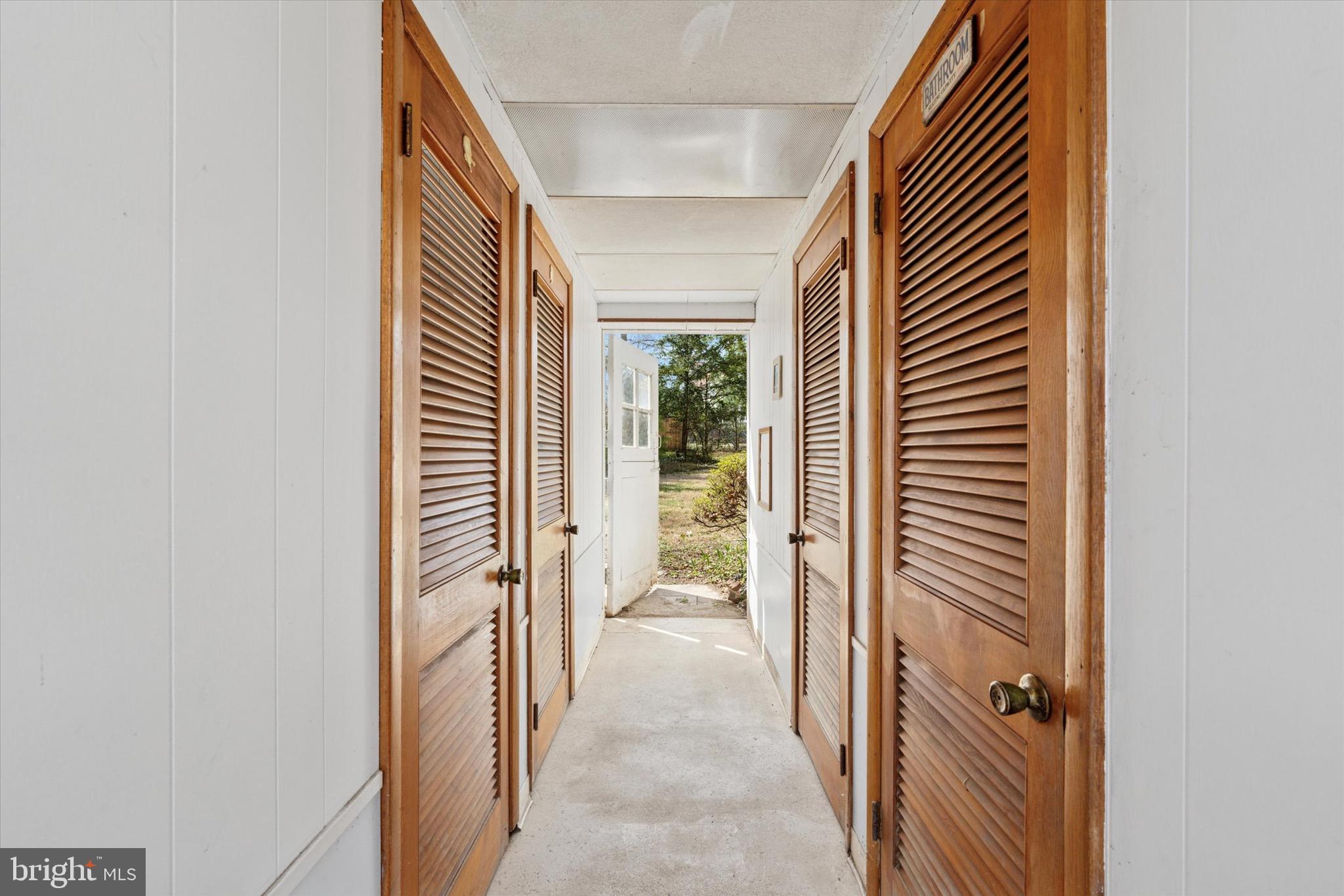 402 Penn Road Wynnewood, PA 19096 - Photo 65 of 75 a view of a hallway with wooden floor and a bathroom