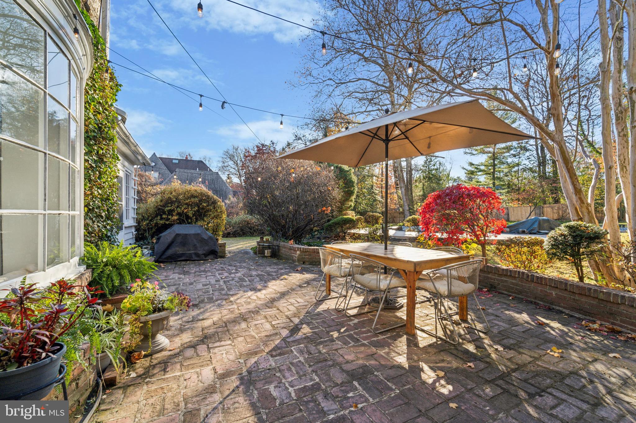 402 Penn Road Wynnewood, PA 19096 - Photo 7 of 75 a view of a patio with a table and chairs under an umbrella