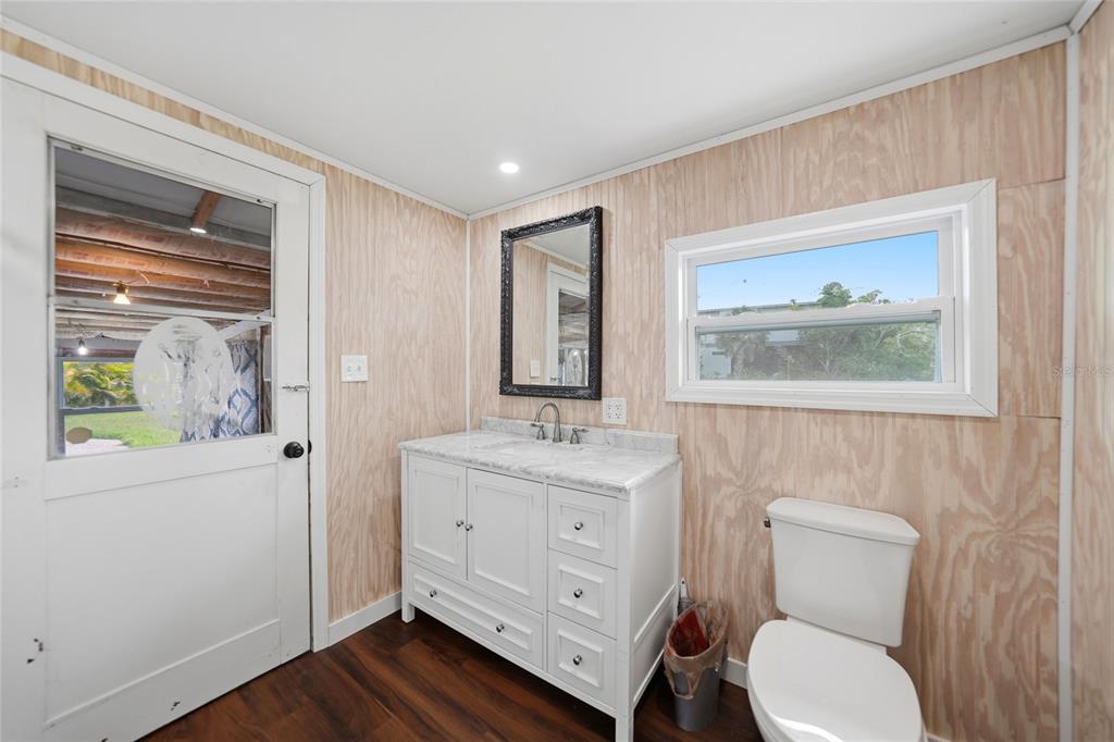 8164 Archie Street Englewood, FL 34224 - Photo 19 of 42 a bathroom with a toilet a sink and a mirror